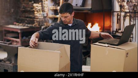 Business man, laptop and stock in boxes for planning logistics, doing inventory and ecommerce. Male person, factory and management of shipping list Stock Photo
