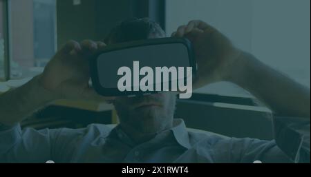 Middle-aged Caucasian male wearing virtual reality headset Stock Photo