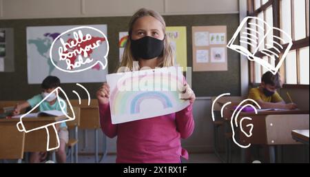 In school, young Caucasian student holding a rainbow drawing stands Stock Photo