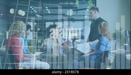 Diverse team of young professionals discussing work in office Stock Photo