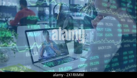 Middle-aged Asian businessman analyzing stock market trends on laptop Stock Photo