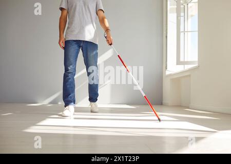 Blind Man Walking at Home using Walking Stick Stock Photo
