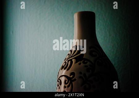 Explore the intricate artistic embellishments and patterns adorning a stylish vase, enhancing interior decor with elegance. Stock Photo