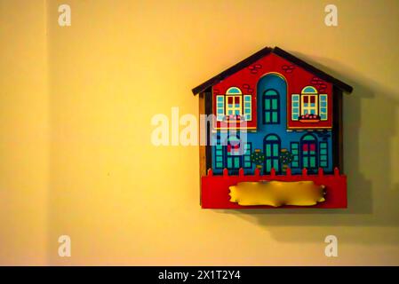 Experience the compact charm of a tiny house biblio adorning the wall, showcasing a stylish and space-saving book display. Stock Photo