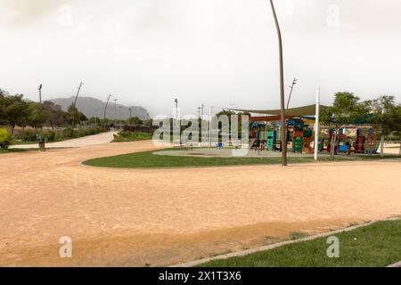 Deserted playground with colorful equipment on overcast day. Stock Photo