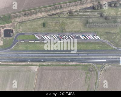 Aerial top down view on truck parking along the road, resting for lorry and road transportation logistics. Highway infrastructure. Stock Photo