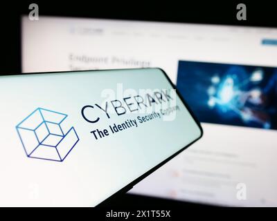 Smartphone with logo of American identity security company CyberArk Software Inc. in front of website. Focus on center-left of phone display. Stock Photo