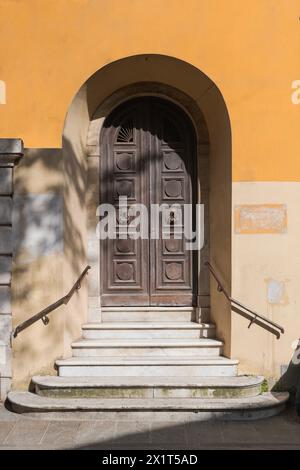 Ancient wooden door with Italian white marble staircase Stock Photo