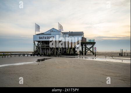 Salt and Silver Restaurant Cafe near St. Peter Ording, North Sea, Germany in the evening with sand of the beautiful beach in front, sunset, horizontal Stock Photo