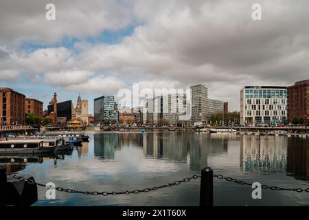 Wide angle panorama of the Albert dock, with the modern buildings reflected in the water. Boats are docked in the marina Stock Photo