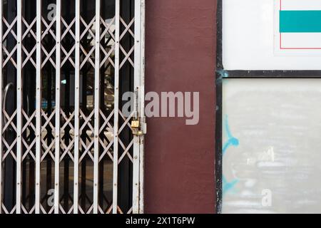 Grunge apartment wall with retractable gate Stock Photo