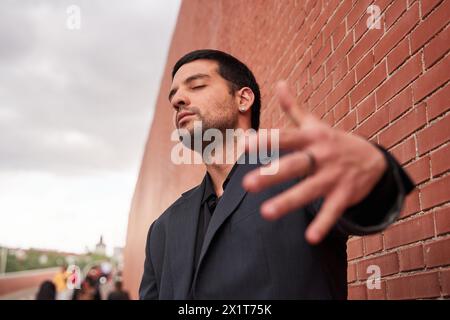 fashionable portrait of a latin man moving his hand in front of his body Stock Photo