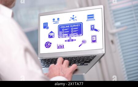 Online survey concept shown on a laptop used by a man Stock Photo
