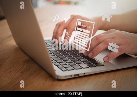 Man typing on a laptop. Invoice concept, flying icons Stock Photo