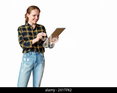 Joyful female entrepreneur working on digital tablet using stylus and smiling. Start-up, e-commerce, isolated picture of businesswoman wearing casual Stock Photo