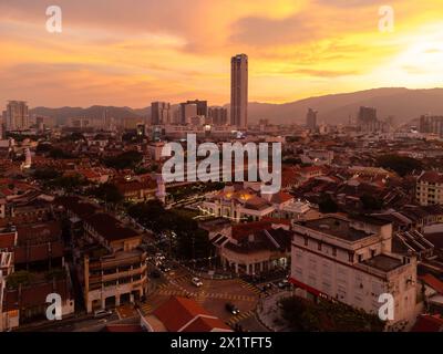 Penang, Malaysia - August 14 2022: The sun sets over Georgetown Little India and colonial district with the Kapitan Keling Mosque Stock Photo