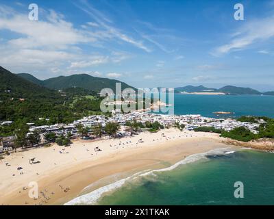 Shek O, Hong Kong: Aerial drone footage of the Shek O beach and town in Hong Kong island on a sunny summer day. Stock Photo