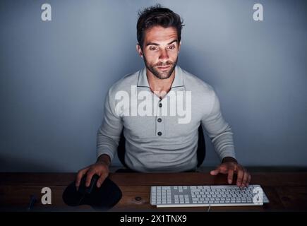 Man, computer and working at night with keyboard in house for design, software and creative. Web designer, technology and remote work late in home for Stock Photo