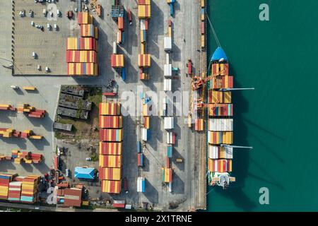 Aerial view of cargo port with container terminal at dock. International freight logistics and trade commerce transportation. Stock Photo