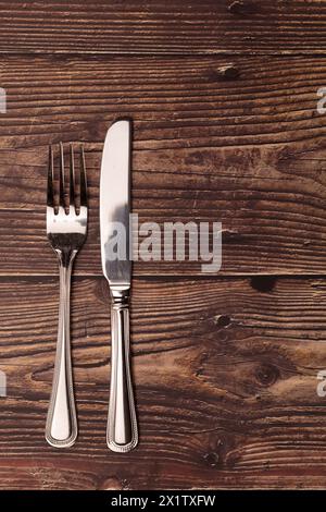 Rustic Table Fork Knife and fork against rustic wood table background with copy space for ...