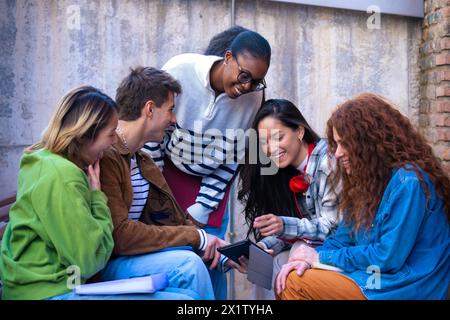 Students having fun with digital tablet creating content on social media. Stock Photo