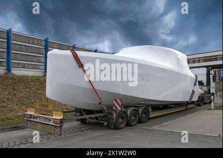 Heavy goods vehicle loaded with a motor yacht in a car park, Mecklenburg-Vorpommern, Germany Stock Photo