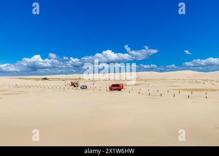 Tourist Trucks driving on Sand Dunes at Stockton Beach, New South Wales, Australia. Stock Photo