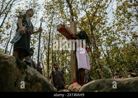 Christian devotees takes part in a perform to re-enactment of the crucifixion of Jesus Christ during a procession on Good Friday, on March 29, 2024 Stock Photo