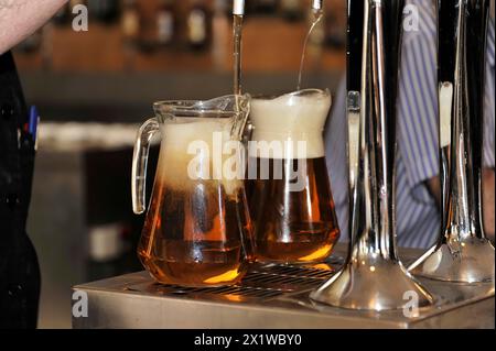 Solabrena, Two mugs of beer are freshly tapped at the bar with foam, Andalusia, Spain Stock Photo