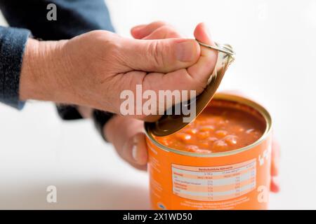 Opening a tin can Stock Photo