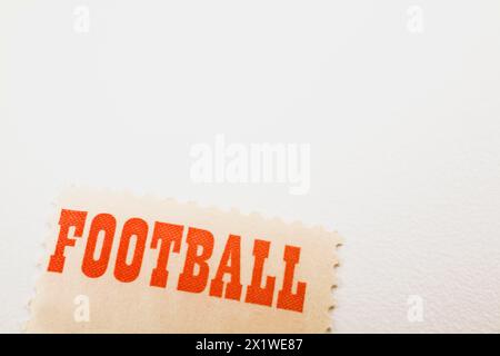 Close-up of the word Football printed in bold red letters on commemorative postage stamp on white background, Studio Composition, Quebec, Canada Stock Photo