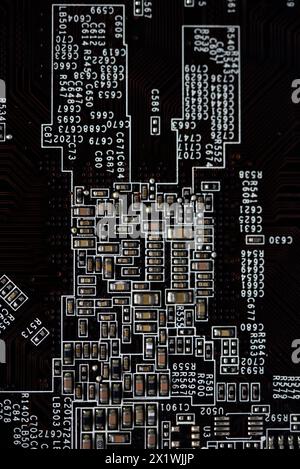 A brown printed circuit board with resistors and capacitors. An electronic board with radio elements. Stock Photo