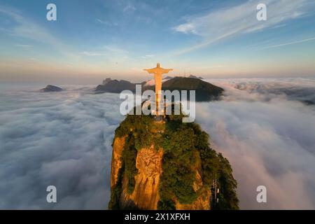 Rio de Janeiro, Brazil - April 11, 2024: Corcovado mountain above clouds with Christ the Redeemer statue on top of it. Stock Photo