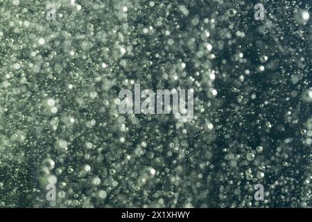 Drops of water in the air on a dark bokeh background Stock Photo