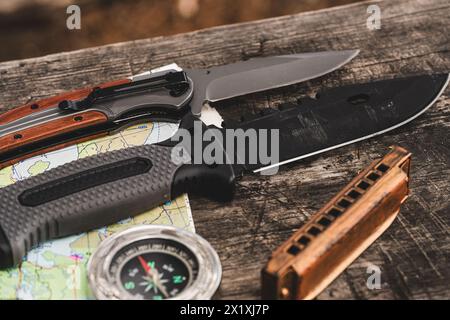 Ready for the journey, knife, compass, harmonica, map set on wooden table Stock Photo
