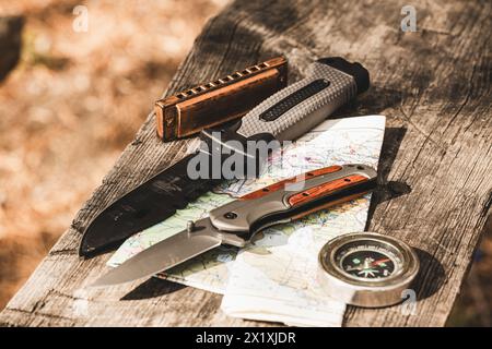 Compass, knife and map on a wooden table. Travel concept Stock Photo