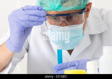 Cropped shot of a young scientist using a pipette to fill test tubes in his laboratory Stock Photo