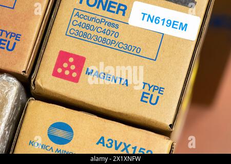 A stack of magenta toner cartridges labeled for Konica Minolta printers is neatly arranged for a stock count or resupply type EU Printer ink cartridge Stock Photo