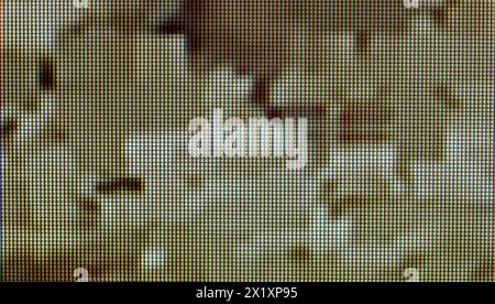 Close-up view of an LCD screen display, chaotic digital glitch pattern, distorted abstract pixelated background texture backdrop, dark yellow green to Stock Photo
