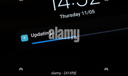 Progress bar indicating an ongoing OS operating system update on a generic mobile device, smartphone, tablet, nobody, screen display macro detail clos Stock Photo