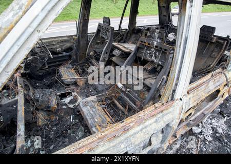 interior seating of burnt out range rover by the side of the road in county antrim northern ireland uk Stock Photo