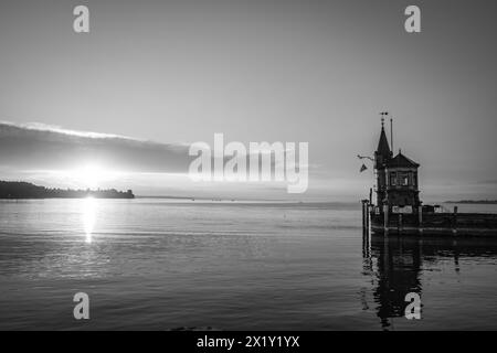 Description: Panoramic sunrise view from Imperia statue to lighthouse at harbor entrance and Lake Constance in early morning hours. Steamer harbor, Co Stock Photo