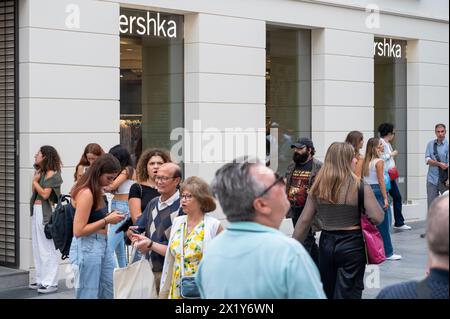 Pedestrians and shoppers walk past the Spanish fashion brand owned by Inditex, Bershka, store in Spain. Stock Photo
