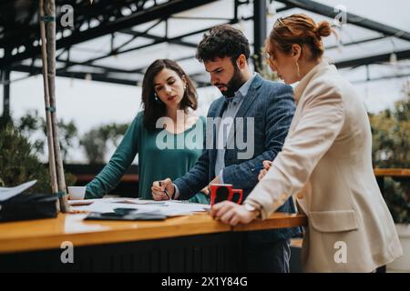 Business partners collaborating on project at outdoor casual meeting Stock Photo