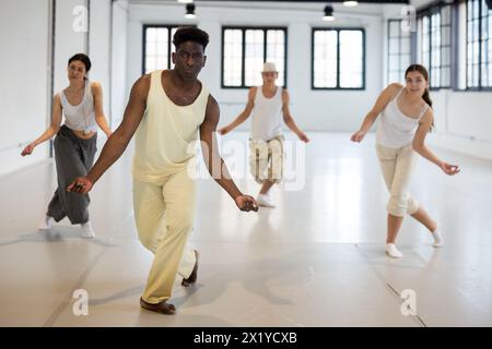 Four dancers exercising swing movements Stock Photo