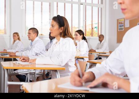 Medical students writing in notepads lesson Stock Photo