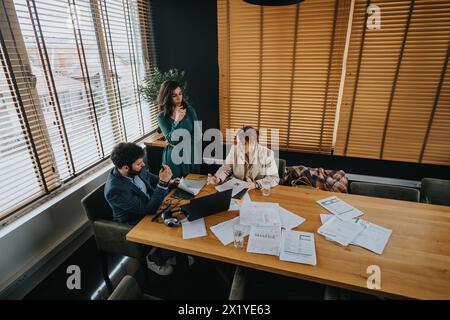 Business associates collaboratively analyzing success metrics in a modern office Stock Photo
