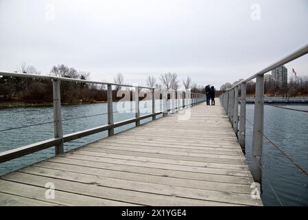 Toronto, Ontario / Canada - March 31, 2018: Couple walking in the bridge in Toronto lakeshore. Stock Photo