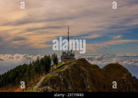 Beautiful Meteorological and Communication Station with Trees on Mountain Peak and Cloudscape in a Sunny Day in Monte Generoso, Ticino, Switzerland. Stock Photo