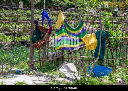 Clothes hung on a fence to dry Stock Photo